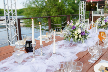 Glasses on the festive table setting. Wedding table decor concept. Table setting in classic style, setout. fine art.