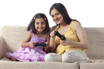 Pregnant woman and her daughter playing video game