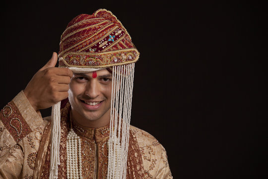 Portrait of a Gujarati groom wearing a headdress 