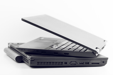 Two Black Laptops One Over Another On White Background
