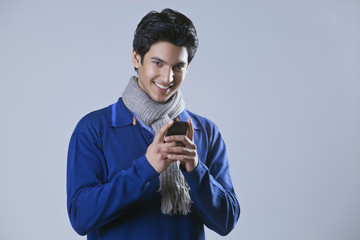 Portrait of young man holding mobile phone 