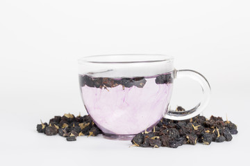 Black goji berry tea on a white background.