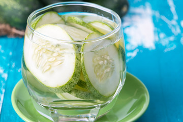 Cucumber water in glass on table