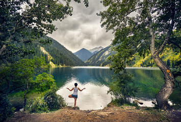 Young woman is practicing yoga outdoors