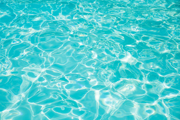 Fototapeta na wymiar Blue and bright ripple water and surface in swimming pool , Beautiful motion gentle wave in pool