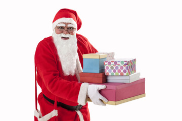 Portrait of smiling Santa Claus carrying Christmas present 