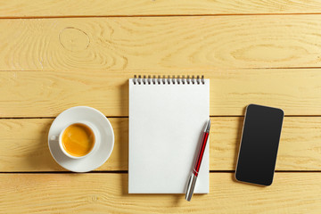 top view. coffee cup with coffee. pen putting on blank notebook.