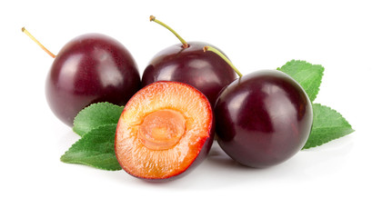 Purple plum with leaves isolated on white background