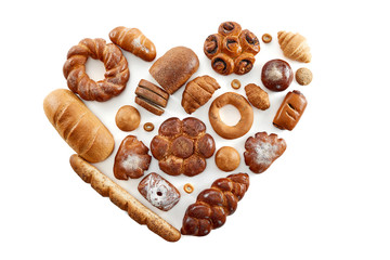Top view studio shot of a heart shaped collection of different delicious freshly baked loafs of bread isolated on white food love nutrition healthy concept. 