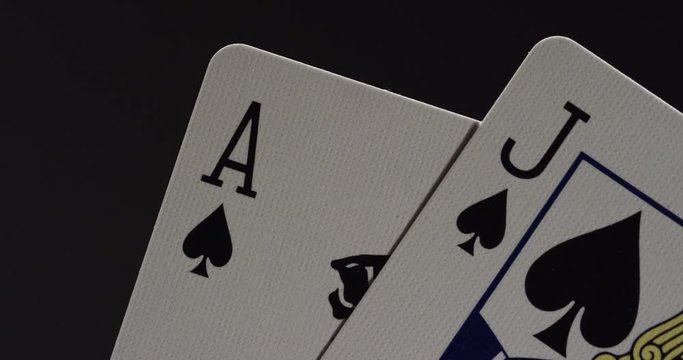 Hand of jack and ace playing cards, close up