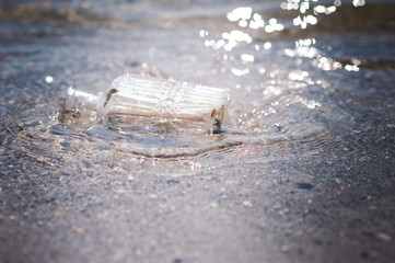Bottle with a note with water, in the sea, in the ocean