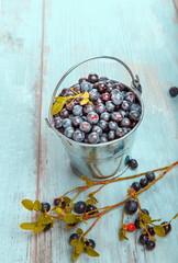 Fresh forest berry, blueberries in a glass plate on a wooden table