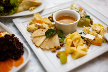 A plate of cheese and crackers on a party buffet table