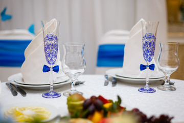 Close up of detail on wedding breakfast dining table setting with champagne glasses.