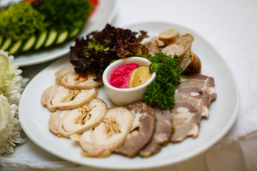 Dish with sliced meat products on the festive table