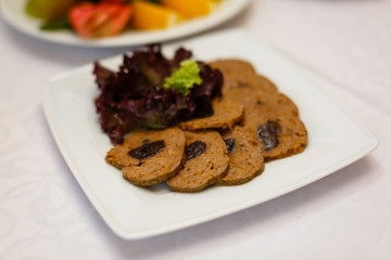 Dish with sliced meat products on the festive table