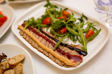 Dish with sliced meat products on the festive table