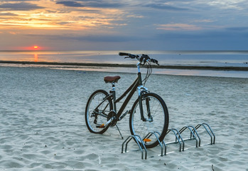 Fototapeta premium Bicycle at sandy beach of Jurmala – famous public domain resort in Latvia, Europe