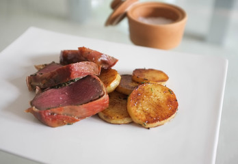 Meal with beef and potatoes on table