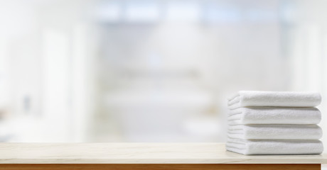 Towels on marble top table with copy space on blurred bathroom background. For product display...
