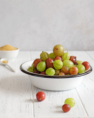Fresh gooseberries in enameled bowl