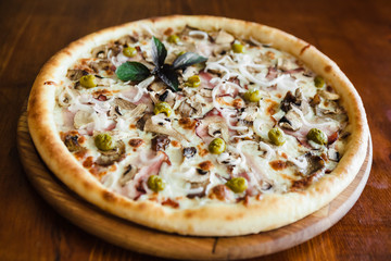 delicious pizza with meat, cheese and mushrooms