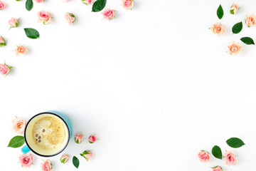 Frame made of pink roses, green leaves and cup coffee