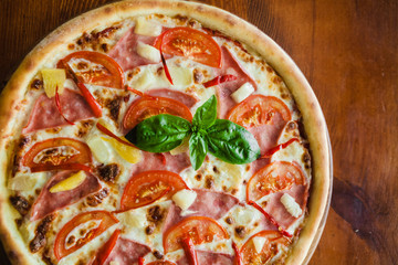 delicious pizza with meat, cheese and mushrooms