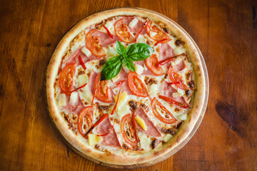 delicious pizza with meat, cheese and mushrooms