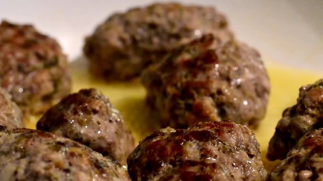 Meat balls of minced beef and pork on frying pan when cooking.