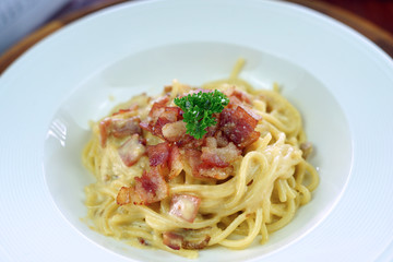 Spaghetti carbonara with fried bacon.