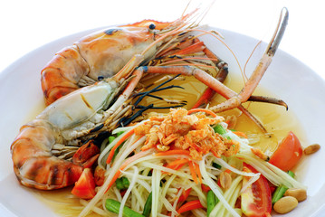 Thai food called "Som Tum" served with grilled shrimp.