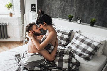 Man and woman making love in bed. Loving couple in bed having sex. Couple in bed. Wedding night. Make love. Lovers in bed. The relationship between a man and a woman. Sex between a man and a woman