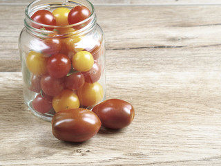 Cherry tomatoes background in a glass jar