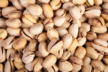 Close up of Pistachios on wooden background in studio photo. Healthy delicious snacks