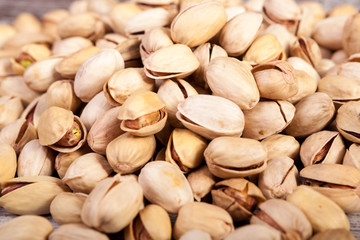 Close up of Pistachios on wooden background in studio photo. Healthy delicious snacks