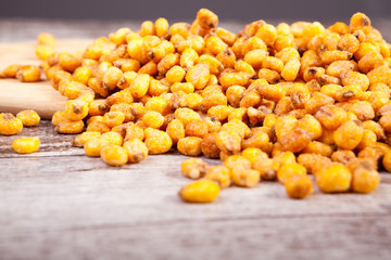 Close up of Roasted corn on wooden background in studio photo. Delicious salty roasted corn