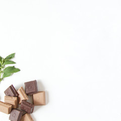 Raw vegan chocolate and mints isolated on a white background. White space for adding text. Healthy sweets. Food background