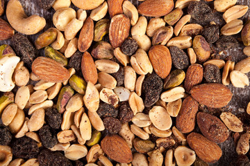 Over top view of Mix from healthy raw nuts on wooden background in studio photo. Healthy organic snack