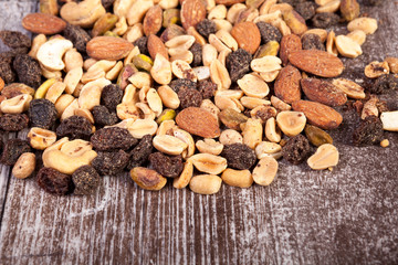 Delicious Mix of healthy raw nuts on wooden background in studio photo. Healthy organic snack