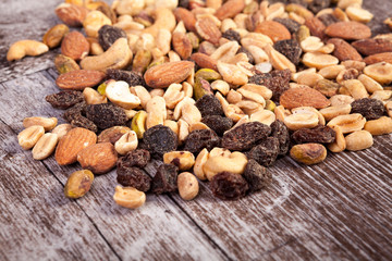 Delicious Mix of healthy raw nuts on wooden background in studio photo. Healthy organic snack