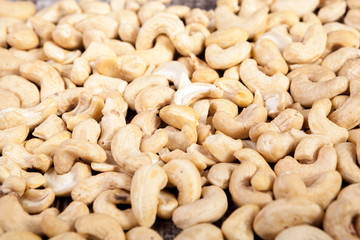 Cashew nuts on wooden background in studio photo. Raw healthy food