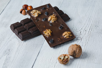 chocolate bar filled with  nuts close-up  lie old wooden table with cracked paint