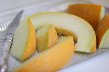 Sliced melon with an ancient knife in retro style