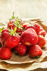 Ripe red strawberries on wooden table