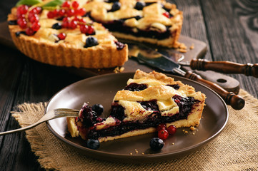 Homemade blueberry pie on wooden background.