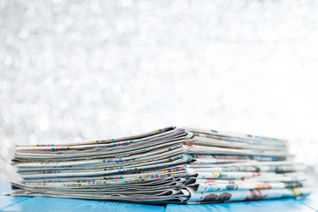 selective focus on stack of newspapers on wooden background