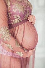 close up woman touching her pregnant belly