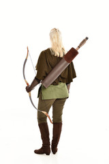 full length portrait of a blonde girl wearing green and brown medieval costume, holding a bow and...
