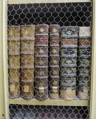 Ancient books in a row protected by a wire screen in a library in Portugal